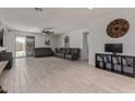 Spacious living room with sleek tile floors, modern ceiling fan, and neutral decor at 20109 W Madison St, Buckeye, AZ 85326