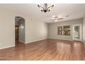 Bright living room features wood floors, a ceiling fan, recessed lighting, and backyard access at 20632 N 103Rd Ave, Peoria, AZ 85382