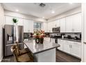Modern kitchen with stainless steel appliances, gray countertops and white cabinetry at 2090 S Dorsey Ln # 1019, Tempe, AZ 85282