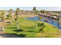 Aerial view of the golf course, featuring lush greenery, palm trees, and the surrounding community at 2249 N Shannon Way, Mesa, AZ 85215