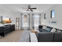 Inviting living room with a cozy sectional sofa, ceiling fan, and bright natural light at 240 W Juniper Ave # 1020, Gilbert, AZ 85233