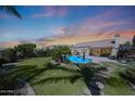 Expansive backyard with pool, patio, lush landscaping, and beautiful desert sunset at 26647 N 43Rd N St, Cave Creek, AZ 85331