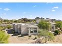 Desert home with uniquely architecture, mature trees, desert landscape, and mountain views at 28729 N 107Th St, Scottsdale, AZ 85262