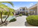 Stunning backyard pool area, complete with lush landscaping and a cozy outdoor seating area at 28729 N 107Th St, Scottsdale, AZ 85262