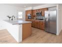 Modern kitchen featuring stainless steel appliances, ample cabinetry, and a stylish island with breakfast bar at 3307 W Mescal St, Phoenix, AZ 85029