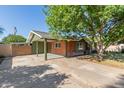 Home featuring a covered parking area with additional driveway space and brick siding at 3538 W Sierra Vista Dr, Phoenix, AZ 85019