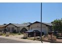 Charming single-story home with mature landscaping and neutral exterior paint at 3935 W Muriel Dr, Glendale, AZ 85308