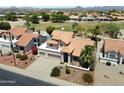 Birds-eye view showcasing a home with a tile roof near a lush green golf course, perfect for relaxation at 4002 N San Gabriel Cir, Mesa, AZ 85215