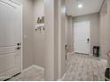 Inviting foyer with tile floors, white doors, and a charming key and mail holder at 41215 W Almira Dr, Maricopa, AZ 85138