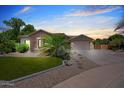Charming home with stone accents, desert landscaping, and a circular driveway at 422 E Kaibab Pl, Chandler, AZ 85249