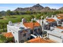 Aerial view of the white condo with red tile roof against golf course and mountain backdrop at 6138 N 28Th St, Phoenix, AZ 85016