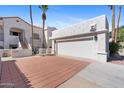 Exterior view of condo featuring a two-car garage and brick paver driveway at 6138 N 28Th St, Phoenix, AZ 85016
