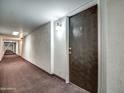 Long hallway with carpet and unit #609 at the end at 7920 E Camelback Rd # 609, Scottsdale, AZ 85251