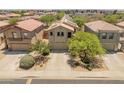 An aerial view of the home with solar panels surrounded by other residential properties at 8259 W Carol Ave, Peoria, AZ 85345
