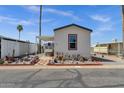 Charming manufactured home showcasing a unique landscape design with desert plants and a welcoming, clean exterior at 8421 E Main St # 116, Mesa, AZ 85207