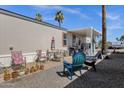 Relaxing outdoor space with comfortable seating, mature palms, and a covered patio for enjoying the Arizona weather at 8421 E Main St # 116, Mesa, AZ 85207