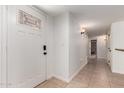 Bright entryway features tile flooring, a decorative glass front door, and a hallway leading to other rooms at 1066 Leisure World --, Mesa, AZ 85206