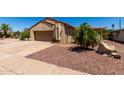 Inviting single-story home with desert landscaping, a two-car garage, and warm curb appeal at 1066 Leisure World --, Mesa, AZ 85206