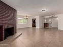 Spacious living room showcasing a cozy fireplace, and neutral tile flooring throughout the area at 1066 Leisure World --, Mesa, AZ 85206