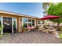 Outdoor living space featuring an outdoor dining table, a patio and a beautifully decorated backyard at 1087 Leisure World --, Mesa, AZ 85206