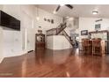 Inviting living area with hardwood floors, high ceilings, and a staircase leading to the upper level at 1120 E Jahns Dr, Casa Grande, AZ 85122