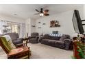 Cozy living room with carpeted floors, ceiling fan, and comfortable furniture, perfect for relaxing at 1662 E Kingman Pl, Casa Grande, AZ 85122