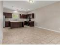 Open-concept kitchen with dark wood cabinetry, an island, and stainless steel appliances at 2000 N 36Th St # 14, Phoenix, AZ 85008