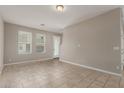 Bright living area featuring neutral walls, tile flooring, and large windows at 2000 N 36Th St # 14, Phoenix, AZ 85008