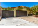 Attractive curb appeal featuring a three car garage, green home, and well-maintained landscaping at 2109 E Gelding Dr, Phoenix, AZ 85022