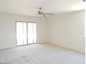 Living Room features a ceiling fan and a sliding glass door to the backyard at 25744 W Winston Dr, Buckeye, AZ 85326