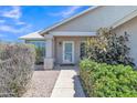 Inviting front entrance with a charming walkway, mature bushes, and ample natural light at 2911 E Leland St, Mesa, AZ 85213
