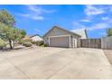 Exterior shot showcasing the two-car garage, a gated entry, and desert landscaping at 2911 E Leland St, Mesa, AZ 85213