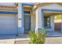 Inviting front entrance with a blue door, decorative trim, and desert-friendly landscaping at 29688 W Indianola Ave, Buckeye, AZ 85396