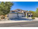 Beautiful home with a three-car garage, desert landscaping, and a classic Southwest architectural style at 29688 W Indianola Ave, Buckeye, AZ 85396