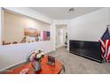 Bright living room with an open layout, decorative niches and an accent wall, next to the flatscreen television at 30186 W Pinchot Ave, Buckeye, AZ 85396