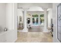 Grand foyer entrance with tile flooring, decorative columns, and views of the backyard pool at 3146 E Maryland Ave, Phoenix, AZ 85016