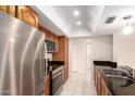Functional kitchen featuring stainless steel appliances and dark countertops and ample cabinet space at 3913 N 86Th St, Scottsdale, AZ 85251