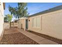 The exterior shows a walkway leading to a front door of a stucco house with a rock landscape at 3955 W Cindy St, Chandler, AZ 85226