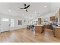 Spacious living area with light wood flooring, white walls, and a kitchen island with light-colored wood cabinets at 3955 W Cindy St, Chandler, AZ 85226