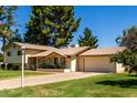Charming two-story home features a well-manicured lawn, mature trees and a welcoming facade at 4145 W Banff Ln, Phoenix, AZ 85053