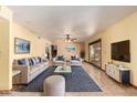 Comfortable living room with stylish furniture, a ceiling fan, and sliding doors to the outside at 4145 W Banff Ln, Phoenix, AZ 85053