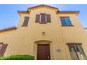 Charming two-story home displaying tan stucco, a red tiled roof, and an inviting front entrance at 4682 E Redfield Rd, Gilbert, AZ 85234