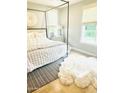 A serene bedroom featuring a four-poster bed, neutral tones, and soft textures for a tranquil retreat at 4824 S Brice --, Mesa, AZ 85212