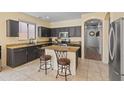 Kitchen featuring granite countertops, stainless steel appliances, and a convenient center island with seating at 4933 W Melody Ln, Laveen, AZ 85339