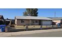Charming single-story home features a two-car garage and a well-maintained front yard and driveway at 5916 W Pierce St, Phoenix, AZ 85043