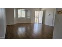 Bright living room with hardwood floors, a bay window, and a secure front door at 5916 W Pierce St, Phoenix, AZ 85043
