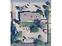 An aerial view of the home showcasing a backyard with a small lawn, desert landscaping, and perimeter trees at 6249 E Larkspur Dr, Scottsdale, AZ 85254
