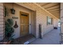 Inviting front porch featuring a welcome sign, plants, and brick accents at 6249 E Larkspur Dr, Scottsdale, AZ 85254