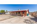 This single-story home has a spacious front yard and covered parking next to the covered entry at 6521 W Flower St, Phoenix, AZ 85033