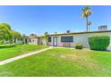 Well-maintained front yard with a walkway to the home's entrance and mature landscaping at 6721 E Mcdowell Rd # B309, Scottsdale, AZ 85257